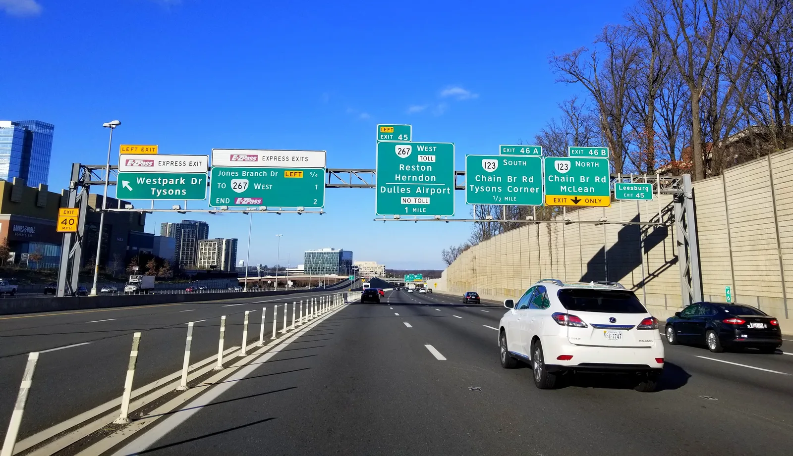 Multi-lane highway with overhead green exit signs for Route 267, Dulles Airport, Tysons and McLean